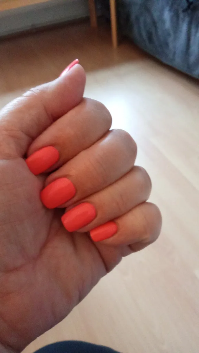 A bright coral-orange square gel manicure